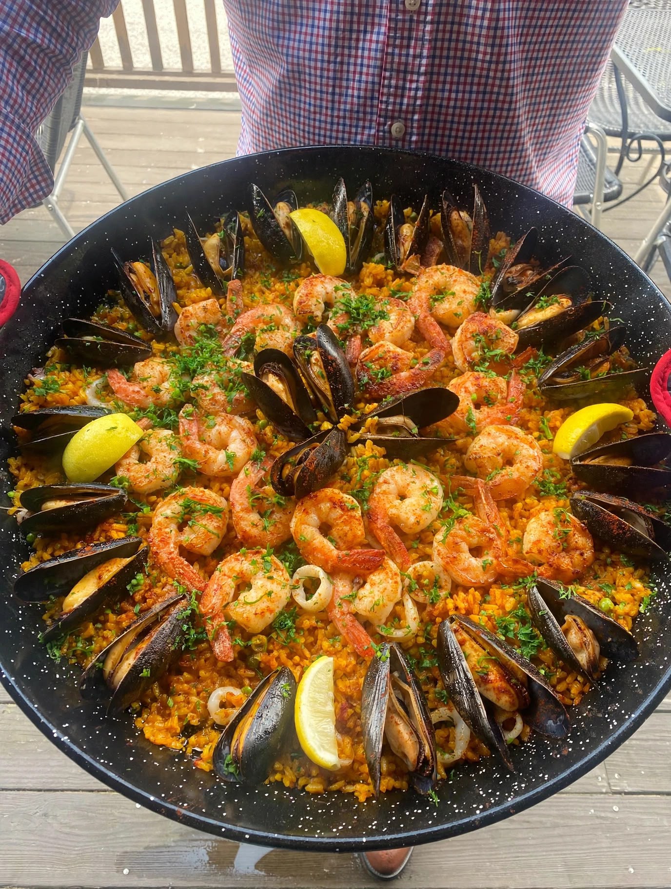 A wide seafood paella — mussels, shrimp, and lemon — at Paella Seafood in Portland, Maine