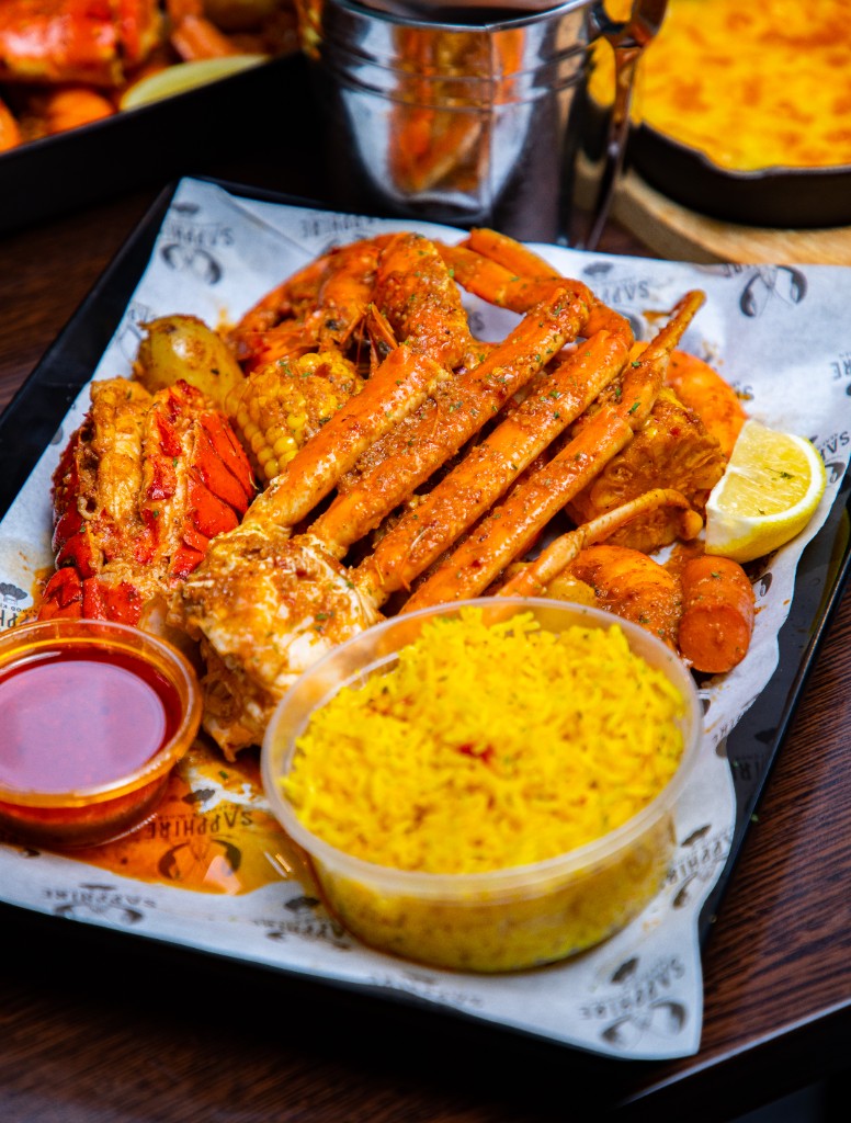 Crab, lobster, prawns, corn, and yellow rice