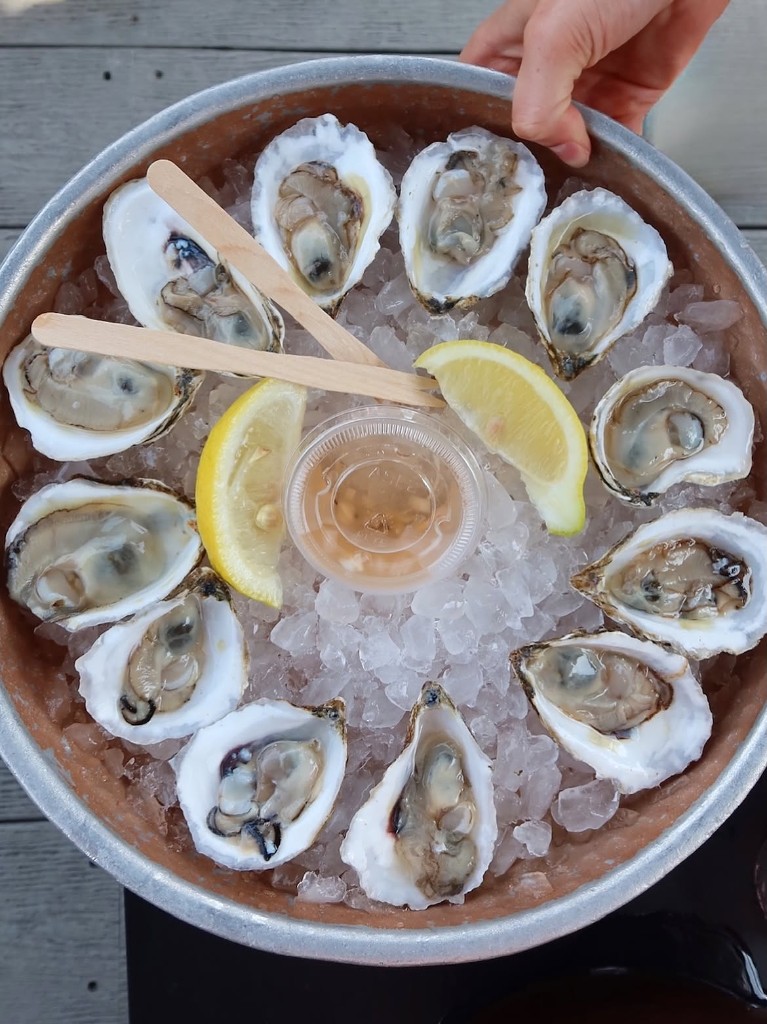 Dozen oysters on ice — mignonette and lemon