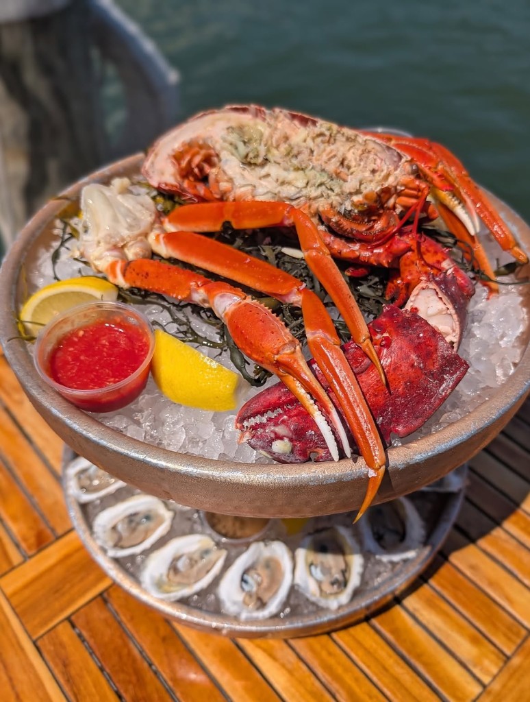 Snow crab legs and half lobster on crushed ice
