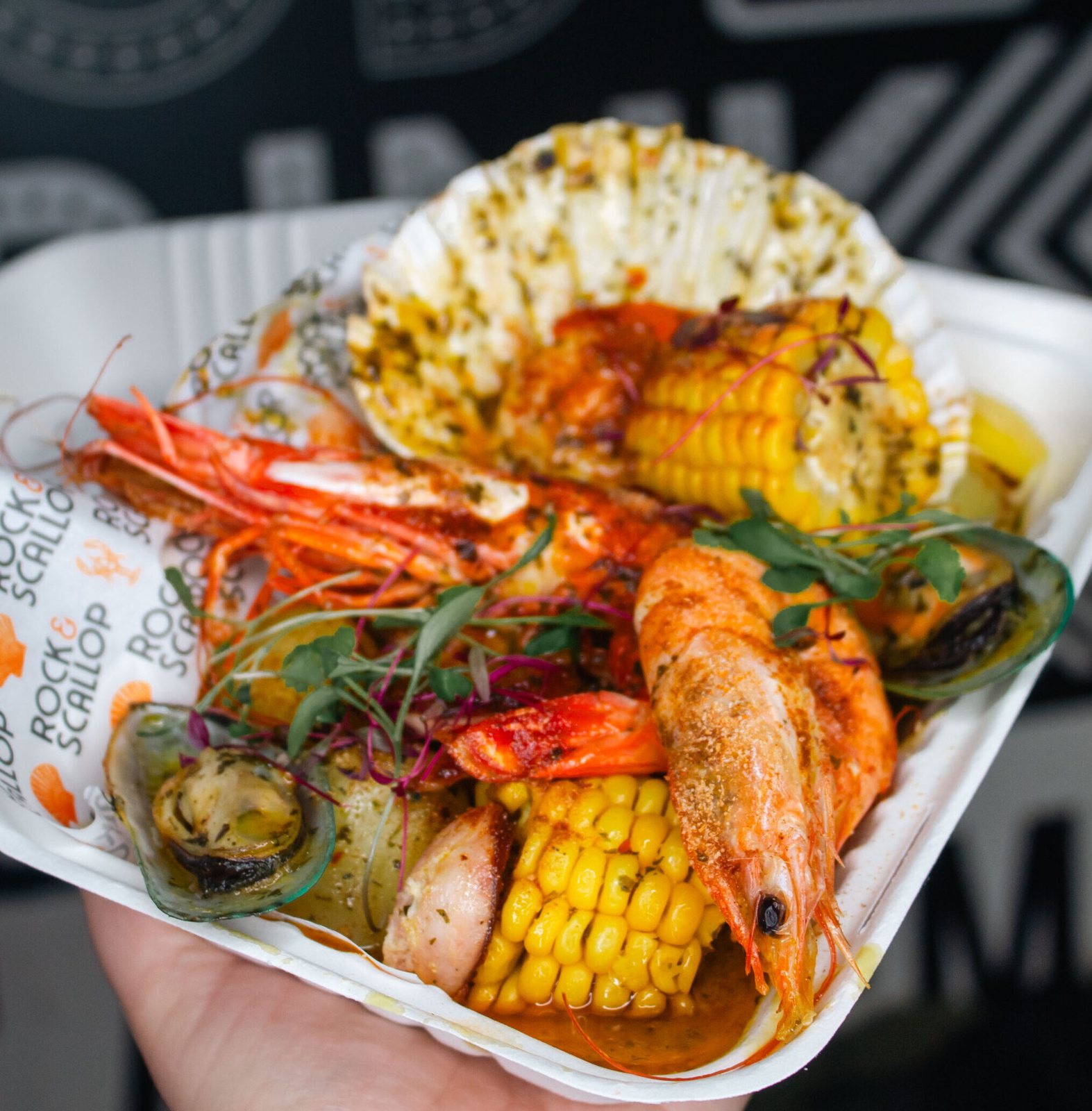 Wild XXXL king prawn, mussels, corn in scallop-shell tray