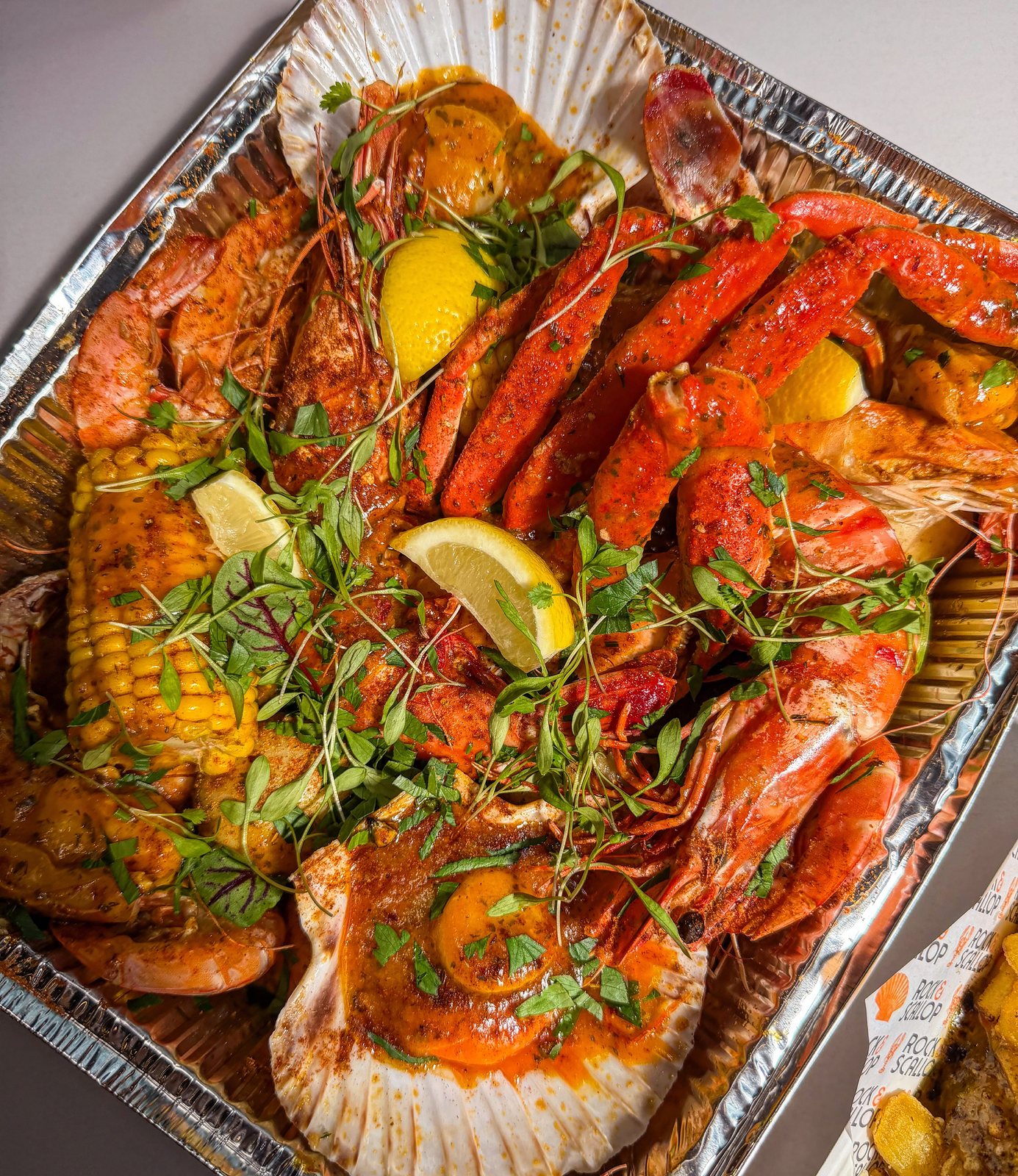 Boil with lobster, scallops, prawns in foil tray